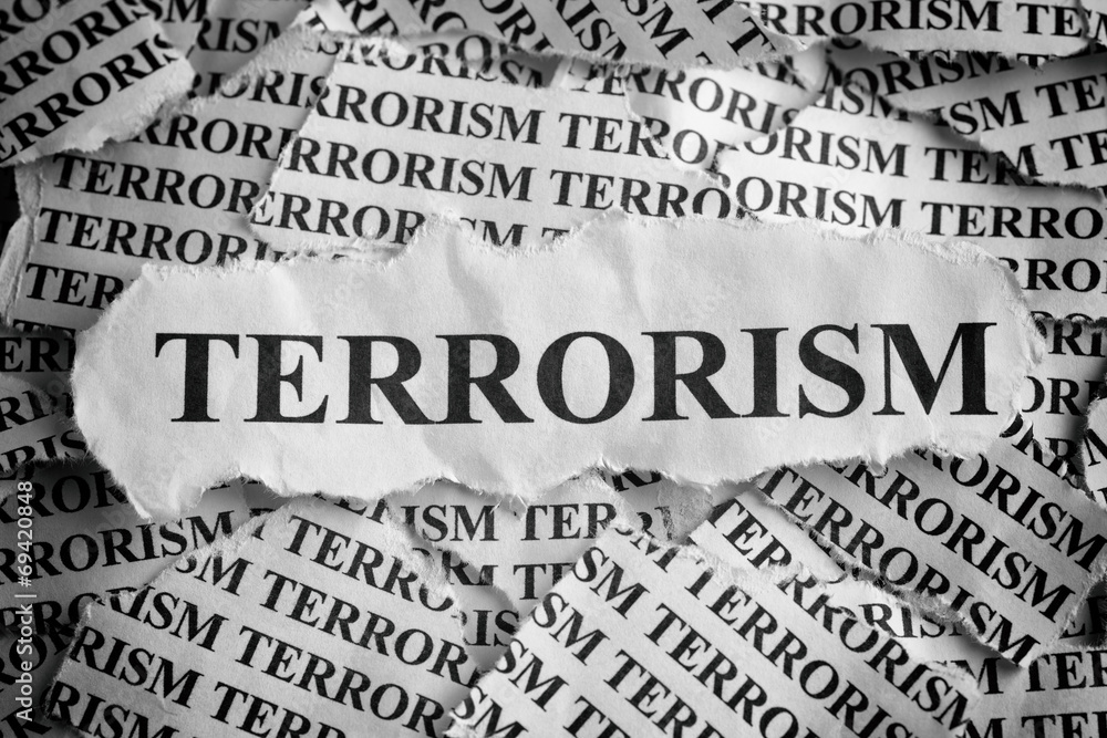 Torn pieces of paper with the word "Terrorism"